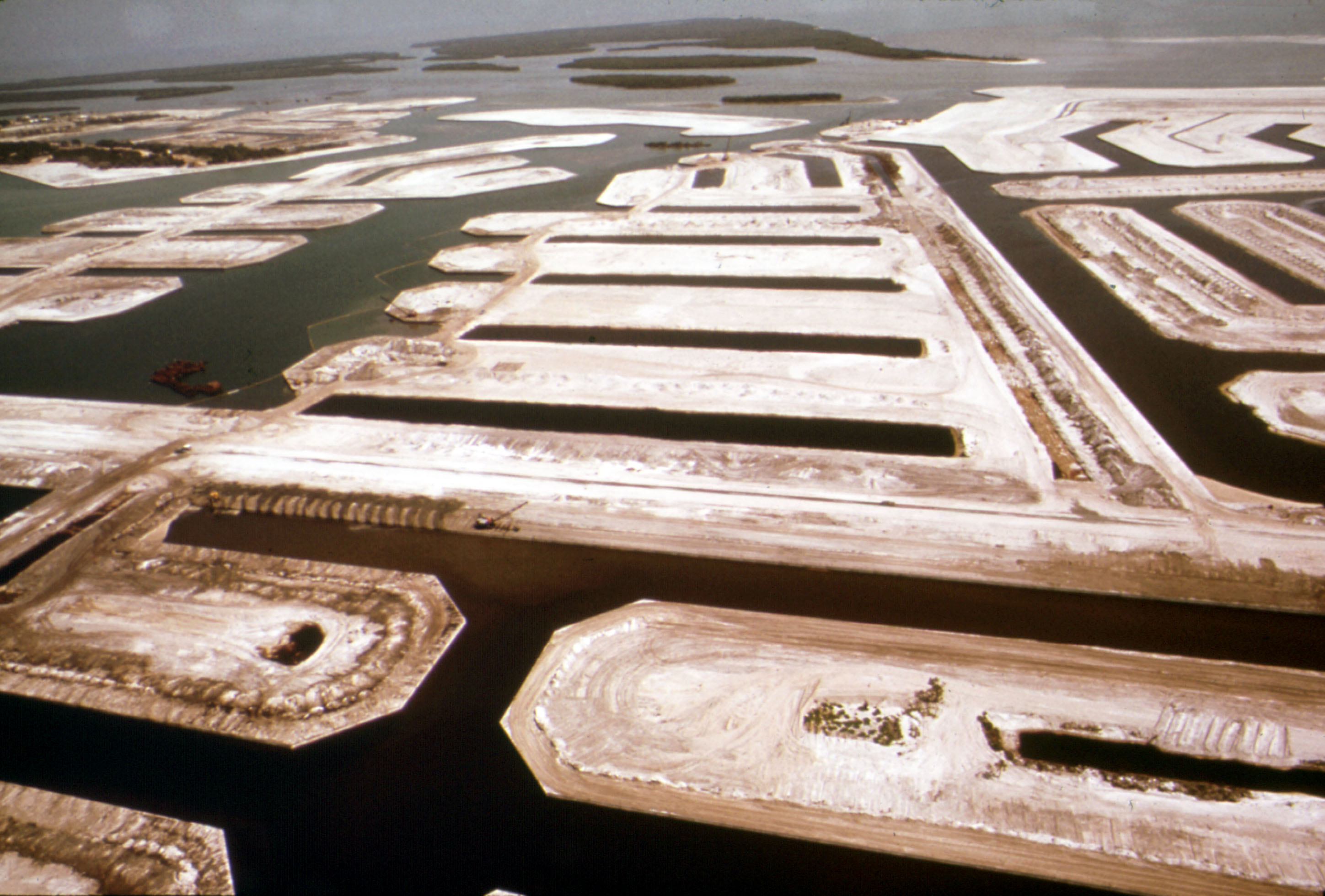 view of empty sandy lots winding through shallow water